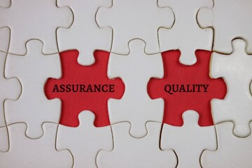 Fototapeta premium Interlocking red Puzzle Pieces Representing Assurance And Quality In Business