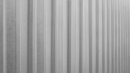 Obraz premium Corrugated metal sheet in gray, industrial striped background texture.