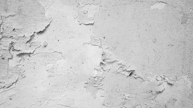 A white wall of a house with peeling paint