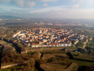 Aerial view of the Vauban-designed star fortress city of Neuf-Brisach, revealing its geometric bastions, fortified walls, and symmetrical urban layout, a masterpiece of military architecture.

