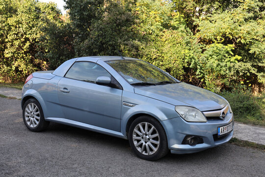 Belgrade, Serbia - October 14, 2025: - Side view of  blue Opel Tigra parked in the street