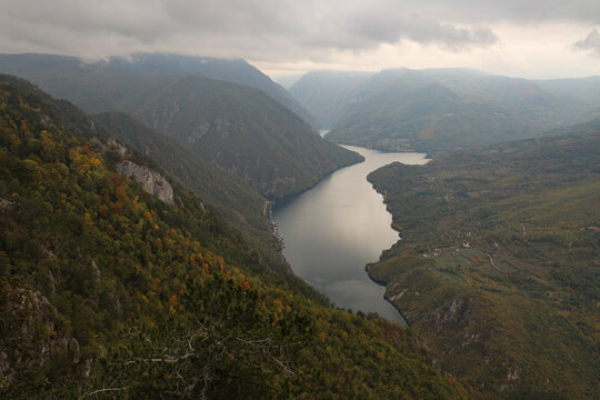 View from Bilje&scaron;ka stena over Perucac Lake and green mountains of Bosnia under sunny sky. Tara National Park, Serbia.
