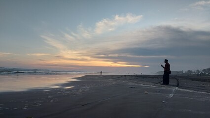man walking on the beach at sunset on the beach