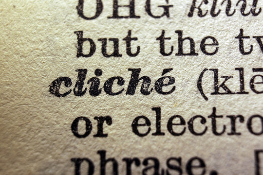 Word cliche printed on dictionary page, macro close up