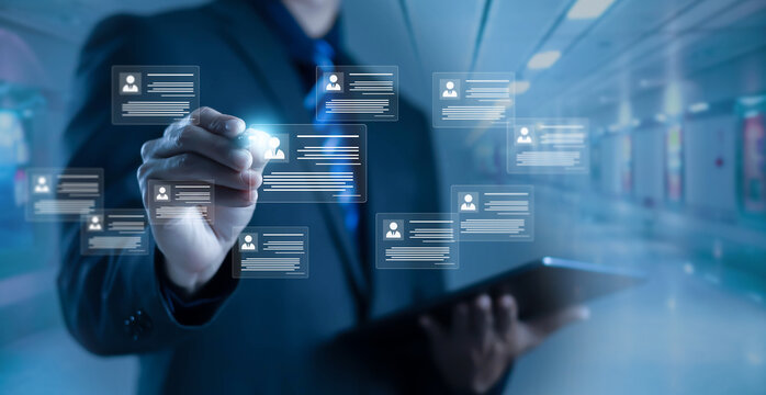 Businessman managing digital user profiles and data cards on virtual interface, representing human resources management, customer data system, digital identity, CRM, and enterprise information network
