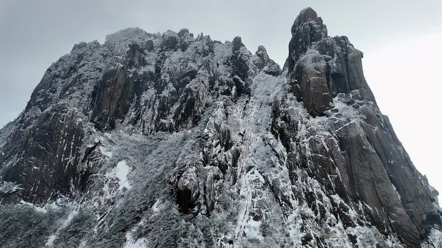 Huangshan, China: Tilt up footage of stairs going up to peak of  frozen Yellow mountain, Mt Huangshan in China during winter