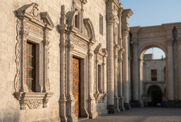 Obraz premium Ornate Spanish Colonial Facade with Intricate Stone Carvings and Decorative Wooden Door in Historic Arequipa Peru