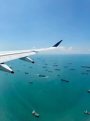 Naklejka premium View from Window of Singapore Airlines A350 with Wing and sea