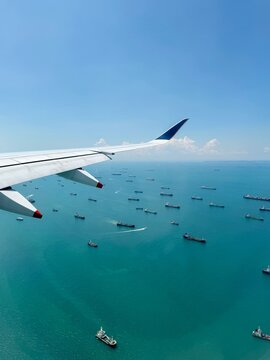 View from Window of Singapore Airlines A350 with Wing and sea