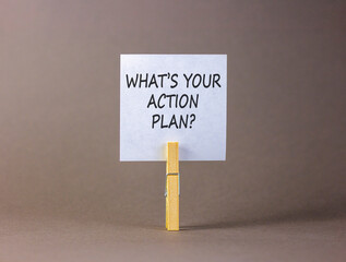 What is your action plan symbol. Concept words What is your action plan on beautiful white paper on clothespin. Beautiful grey background. Business what is your action plan concept. Copy space.