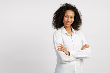 Confident successful African American woman wearing casual white shirt looking at camera