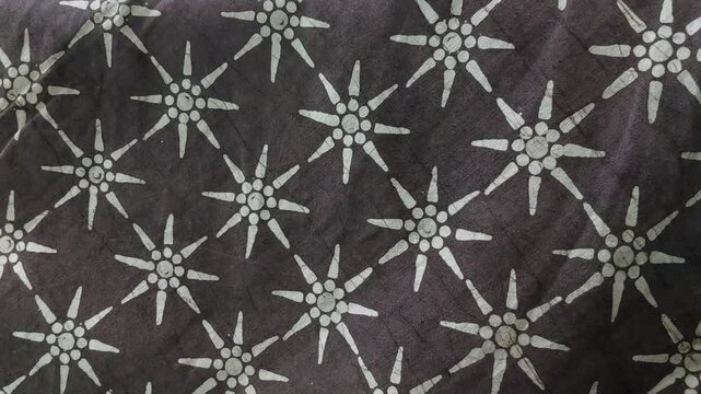 Brown batik motif glowing softly like warm sunlight
