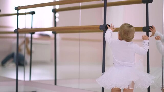 Moscow, Russia,04.04.2024 Little girl in white tutu dance at ballet studio. Tiny ballerina practice for first classical dance lesson. Pre-kindergarten class.
