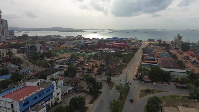 The expansive aerial view shows a bustling port and ever-evolving urban architecture in this dynamic coastal city.