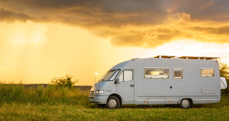 Obraz premium Sunset sky over caravan camping on nature.