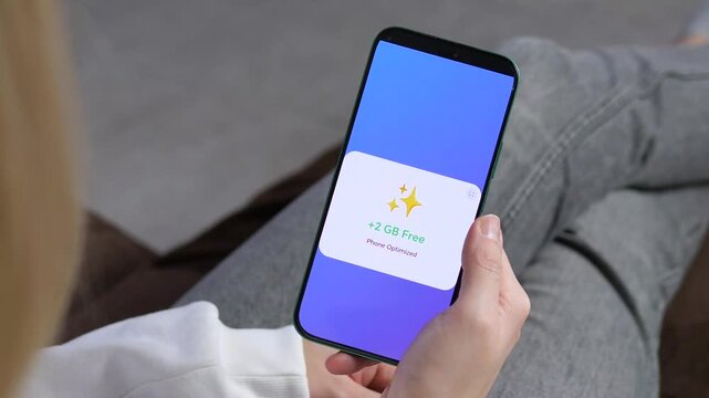 Professional shot of a user interacting with a storage cleaner app. Featuring rocket animation and storage clearing notification. Ideal for content about digital hygiene, system maintenance, and