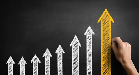 A person's hand draws a yellow arrow on a chalkboard, representing growth and success, with several white arrows