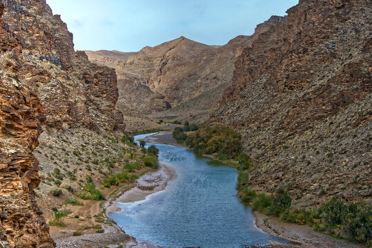 Atlas mountains river flowing through a desert canyon