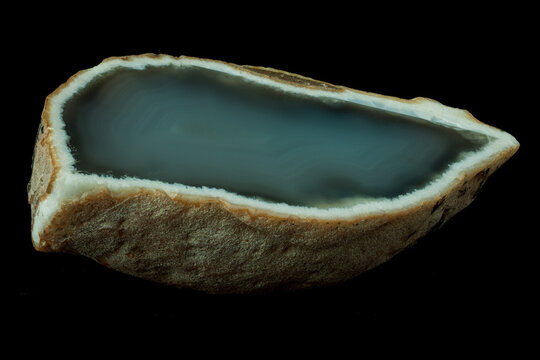 Polished agate slice with beautiful blue chalcedony center and white crystalline border