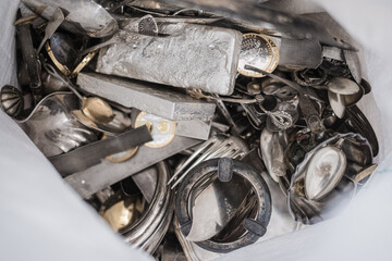 Scrap silver metal jewellery pile for recycling and refining. Scrap silver purchasing and sale. Precious metal industry.