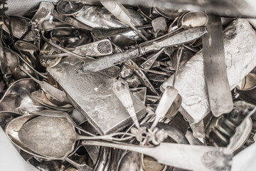 Scrap silver metal jewellery pile for recycling and refining. Scrap silver purchasing and sale. Precious metal industry.