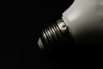 Basra, Iraq - January 21, 2026: Macro Shot of LED Light Bulb Screw Base On Dark Backgro