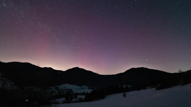 Red Aurora Borealis Dancing in Starry Winter Sky over Central Europe Countryside