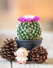 Cactus with Pink Flowers, Pine Cones, and a Small Figurine.