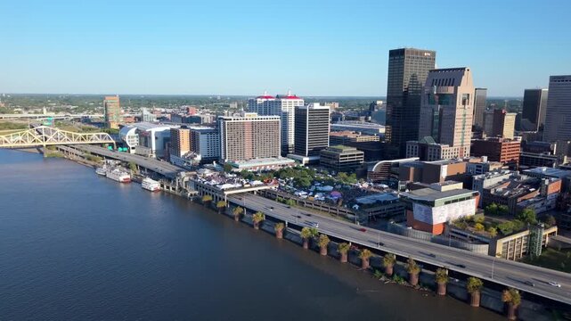 Downtown Louisville, Kentucky city skyline with a view of the Ohio River - sliding aerial reveal at daytime