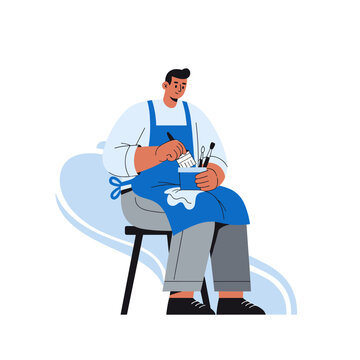 Male artist with blue apron painting on stool