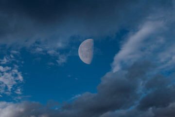 Clouds Pass in Front of Half Moon