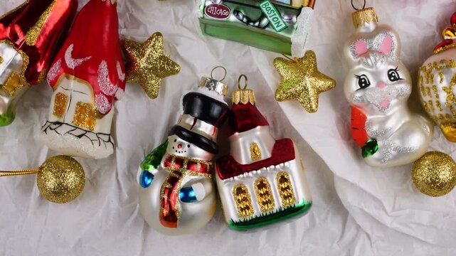 Festive holiday travel decorations on white background. Vintage-style Christmas ornaments featuring city names like Boston, New York, Paris, Chicago and Los Angeles. 