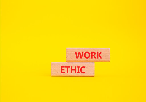 Work Ethic symbol. Concept words Work Ethic on wooden blocks. Beautiful yellow background. Business and Work Ethic concept. Copy space.
