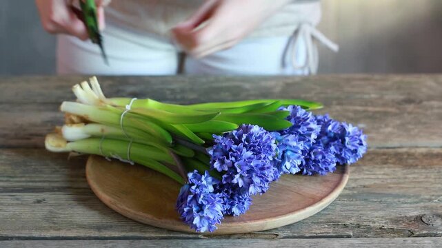 Florist at work: a woman shows how to make a charming vase and candle holders for Valentine's Day from ordinary jars. Step by step, tutorial. Images available.