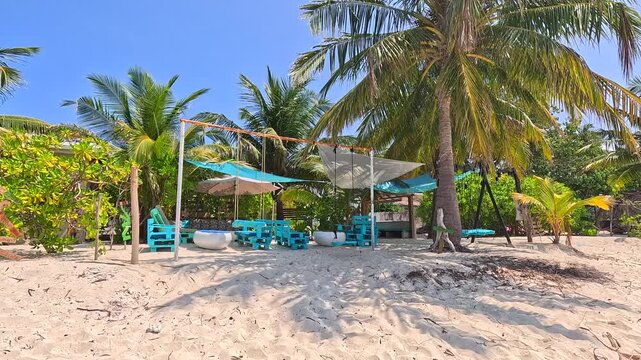 Empty white sand beach in Ukulhas Maldives with palm trees and turquoise water