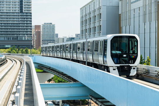 Tokyo, Japan- August 5, 2025: View of a New Transit Yurikamome line train running on the elevated track in Koto, Tokyo, Japan. It's an automated guideway transit service in Tokyo.