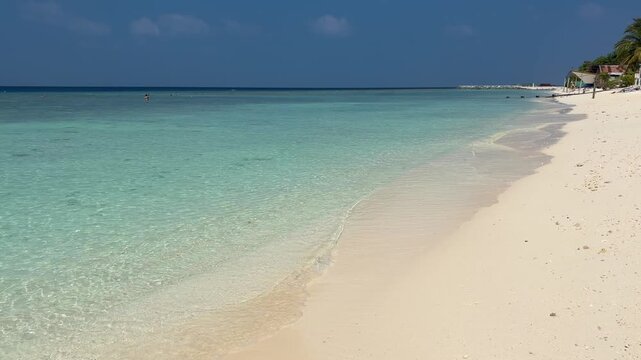 Empty white sand beach in Ukulhas Maldives with palm trees and turquoise water