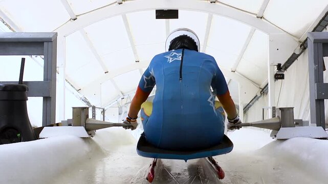 Luge athlete pushing off the starting gate