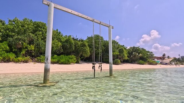 Empty white sand beach in Ukulhas Maldives with palm trees and turquoise water