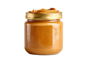 Creamy peanut butter fills a glass jar with a gold lid, against black