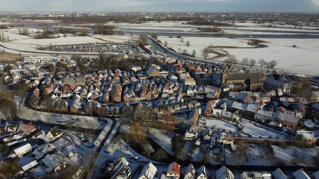Aerial footage of a snow covered  Dutch town of Hattem in winter time. 