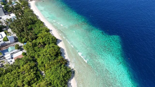 Aerial drone view of Ukulhas island Maldives surrounded by turquoise lagoon and white sand