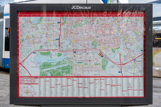 January 23, 2026, Amsterdam, Netherlands - JCDecaux public map display for Amsterdam Zuid with a tram in the background
