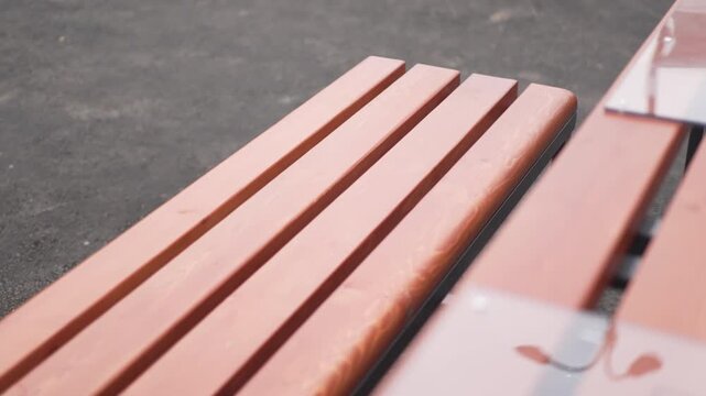 Park benches complement outdoor chess table creating social leisure zone. Seating supports observation conversation and relaxed gameplay