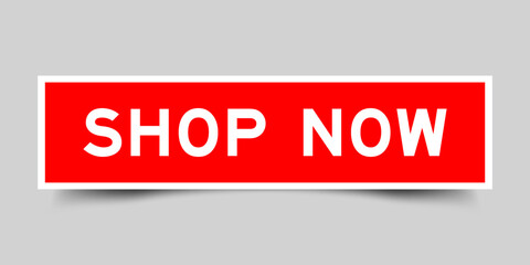 Red color square shape sticker label with word shop now on gray background