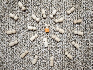 Wooden figurines represent concepts of leadership and social influence in a circular arrangement