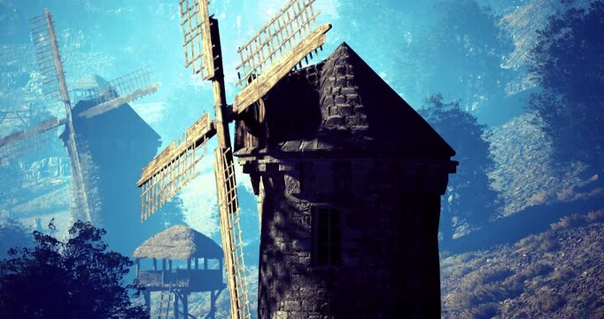 A rustic windmill towers above a tranquil countryside, showcasing its weathered wooden blades. The surrounding hills and trees create a peaceful atmosphere under bright daylight.