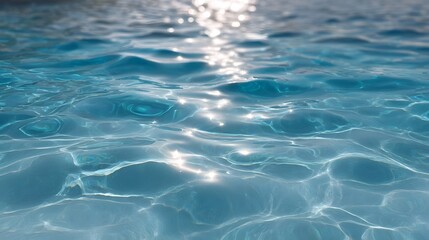 Obraz premium Close up of a shimmering blue water surface with bright sunlight reflections creating dynamic patterns