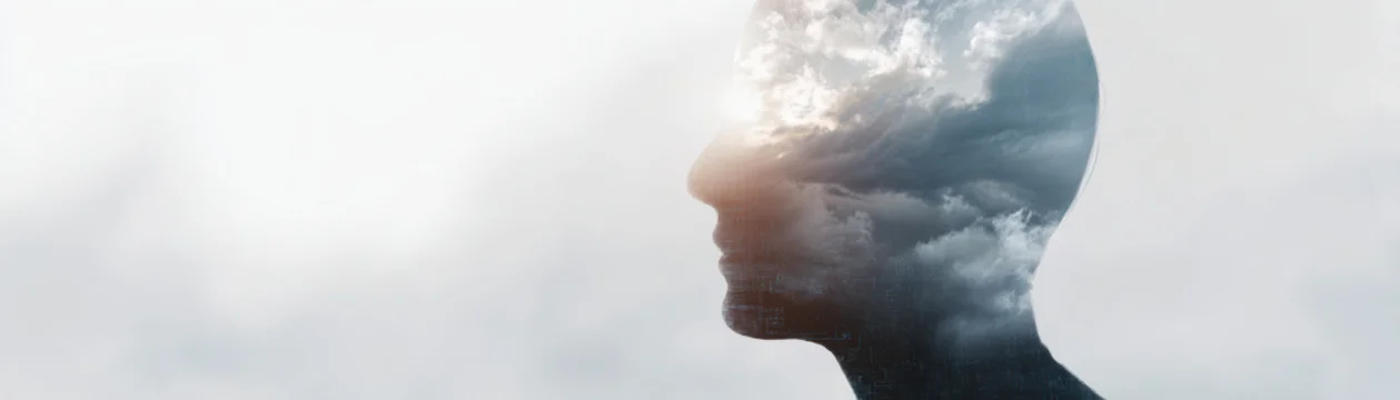 Digital literacy concept with human profile and cloudy sky overlay symbolizing knowledge and imagination in creative artistic style