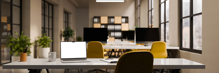 3D rendering of a modern open plan office with laptop on working table